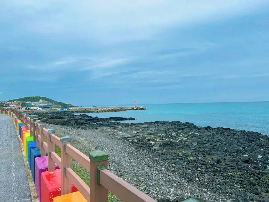 Rainbow railings along the lava coast.