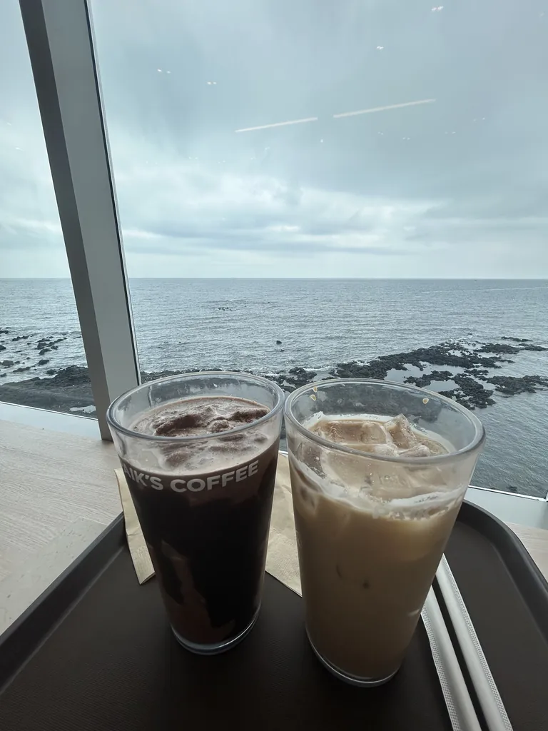 Iced coffee facing the lava rocks.