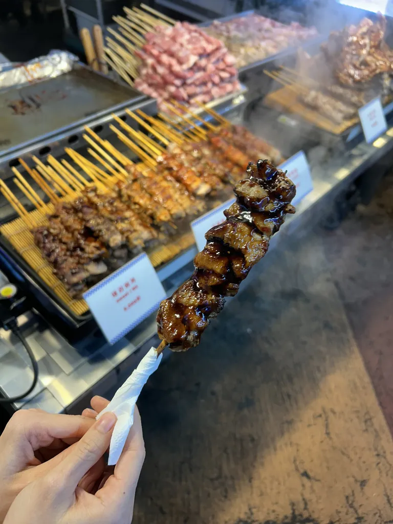 A skewer at the market, still smoking.