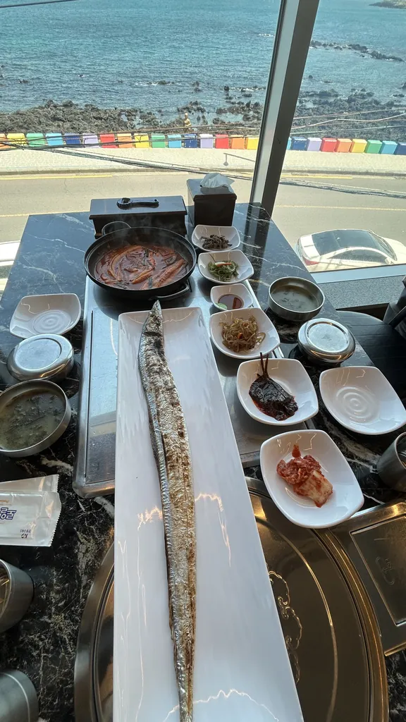 Grilled cutlassfish, longer than the plate.